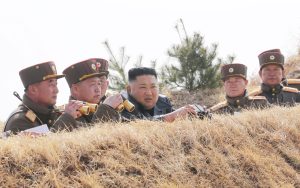 North Korea's Kim 'drives' new tank during mock battle