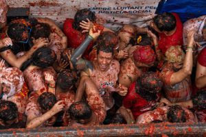 Spanish town gets soaked in red during tomato-lobbing Tomatina festival