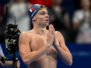 Paris 2024: 'Hurting' Marchand restarts pool party in 200m individual medley