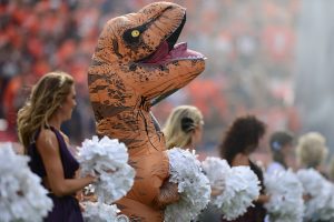 'T-Rexes away!' Runners in dinosaur costumes compete at Washington racecourse
