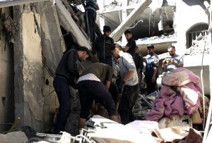 As Israel hammers north Gaza, Palestinians dig for the dead in multi-storey ruins