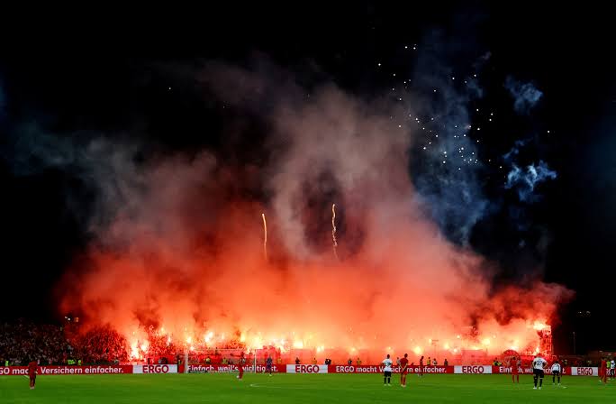 Bayern Munich fined 150,000 euros after fans disrupt Cup game with flares, fireworks