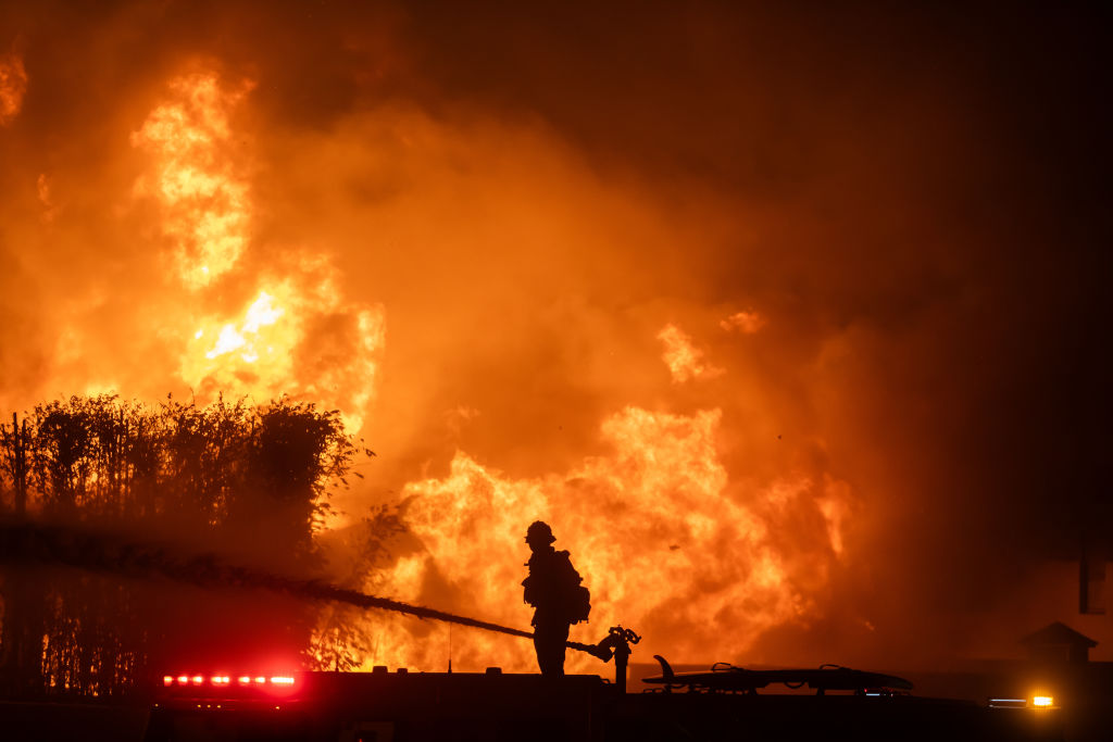 Aerial assault aims to stem LA Palisades fire eastward spread