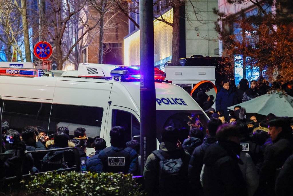 A police vehicle stops at the entrance to the presidential residence of Yoon Suk Yeol, as police and investigators stand guard, in Seoul, South Korea, on January 15, 2025. Photo by Daniel Ceng/Anadolu via Getty Images