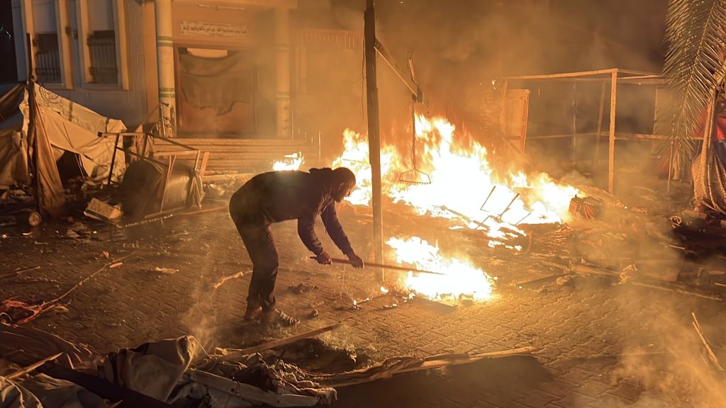 Palestinians are trying to extinguish the fire that broke out as a result of an Israeli army attack targeting tents sheltering displaced Palestinians, despite the ceasefire agreement in Gaza between Hamas and Israel in Deir al-Balah, Gaza on January 16, 2025. Photo by Anas Zeyad Fteha/Anadolu via Getty Images