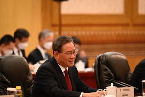China will work to firmly advance 'reunification' with Taiwan, premier says