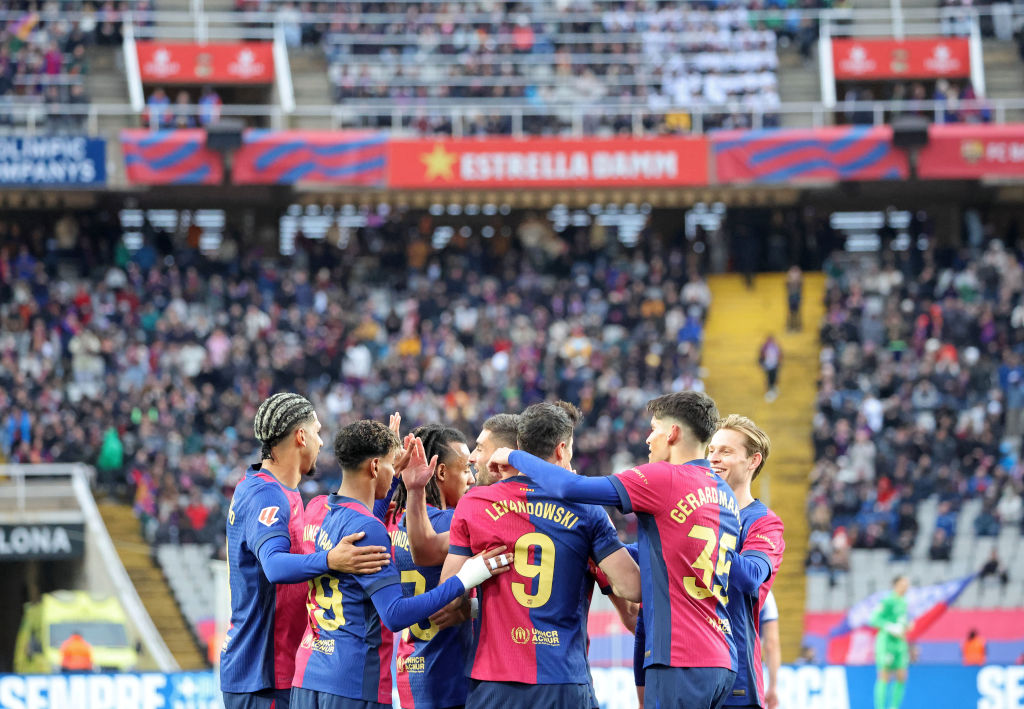 Barcelona reclaim top spot with 4-0 win over 10-man Sociedad