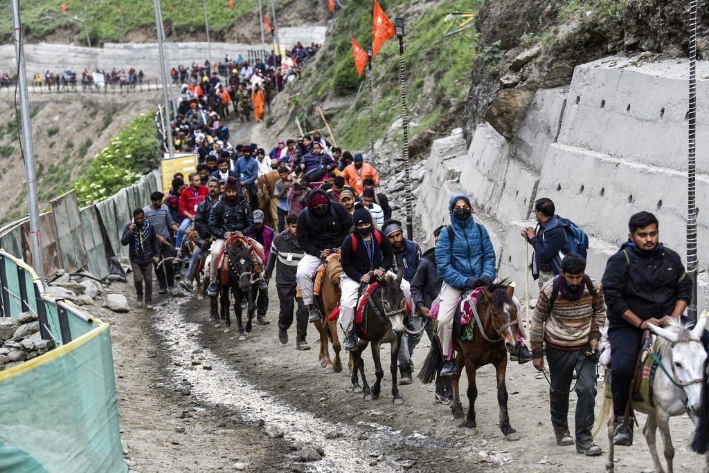 Pilgrims avail horse services to reach the cave shrine