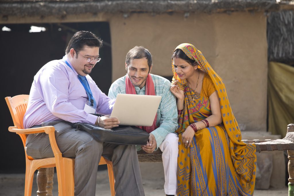 Real estate agent with client at village