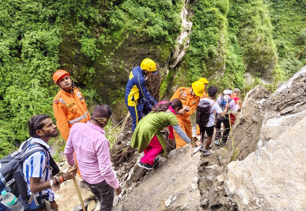 Rudraprayag: NDRF personnel help pilgrims cross a landslide-affected area