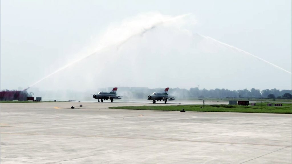 A water salute is being given to the MiG-21 aircraft
