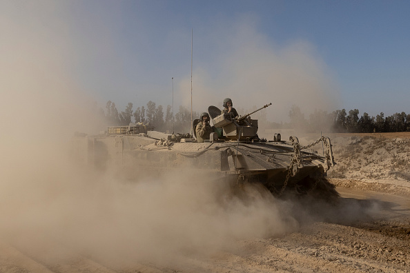Thousands of Israeli reservists report for duty, as military chief clashes with ministers
