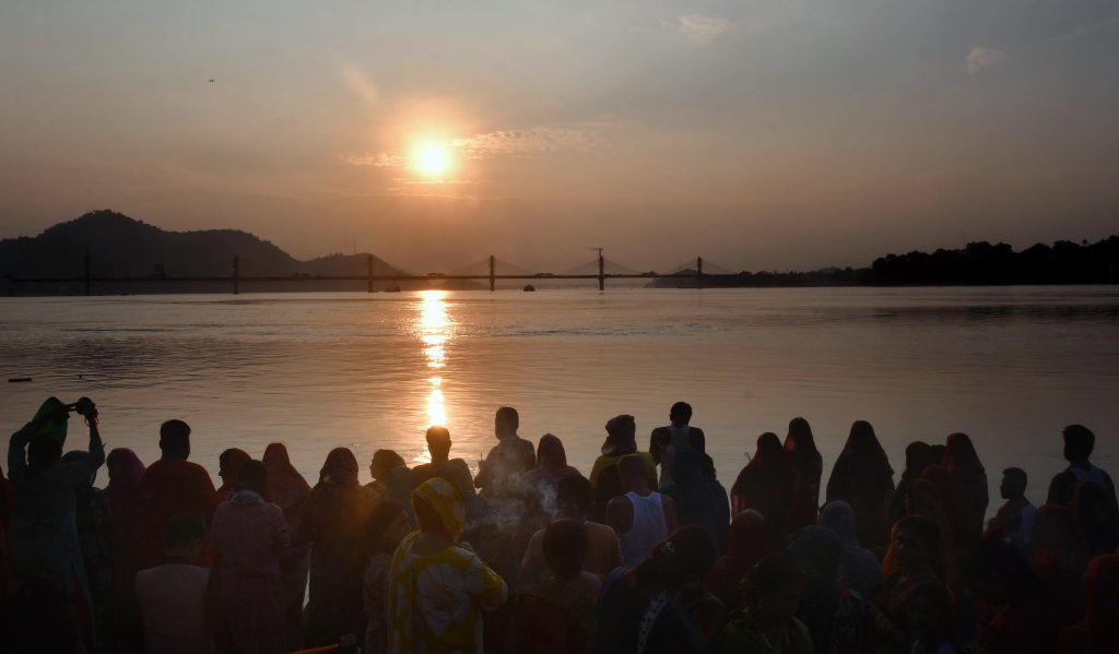 Devotees perform rituals on the bank of the Brahmaputra river