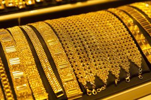 Gold falls nearly 1%, silver slips up to 2% on firm dollar