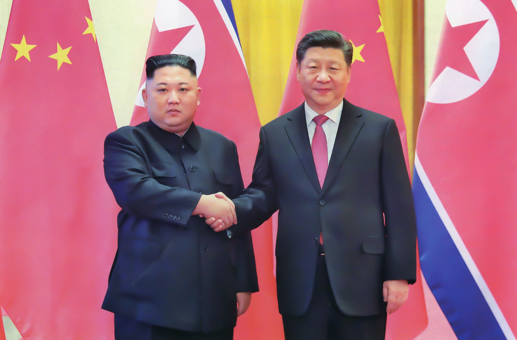 Flags, gun salute greet China’s Xi on arrival in North Korea for summit