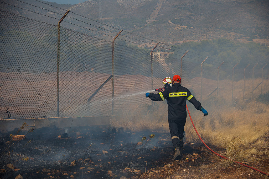 Wildfires ease in Greece as people return to gutted homes