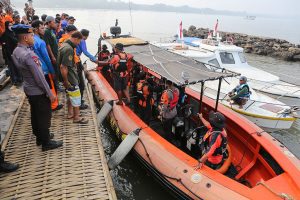 Indonesia rescuers battle turbulent seas in search for 129 people after passenger ship capsizes