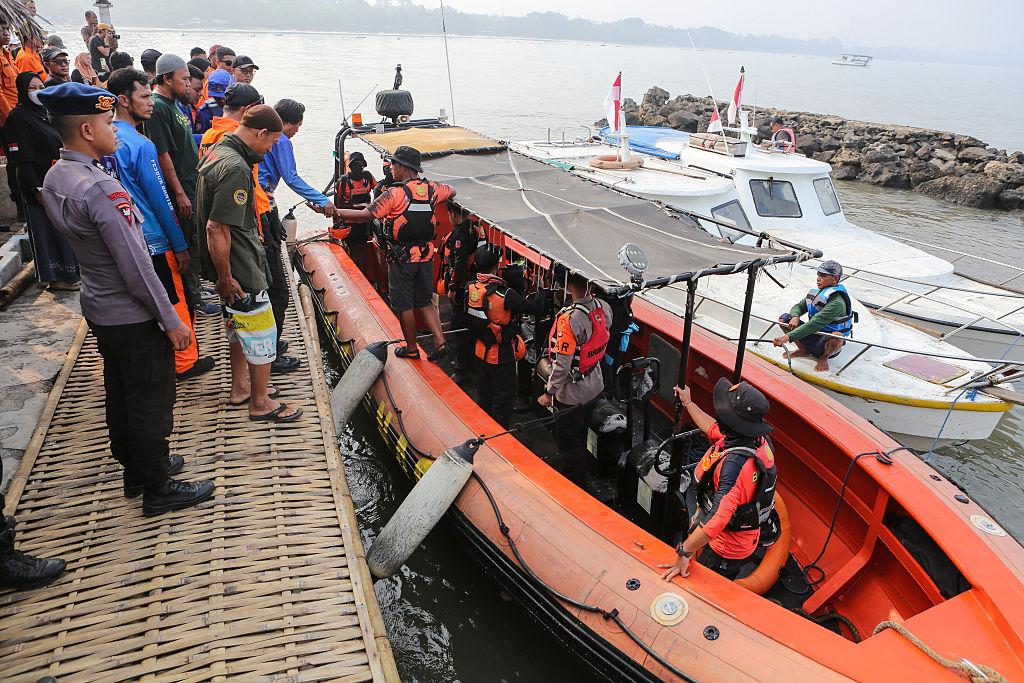 Indonesia rescuers battle turbulent seas in search for 129 people after passenger ship capsizes